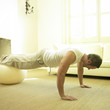 A man doing push up with fitness ball