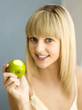 Portrait of woman holding a green apple