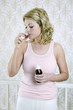 A woman drinking cough syrup