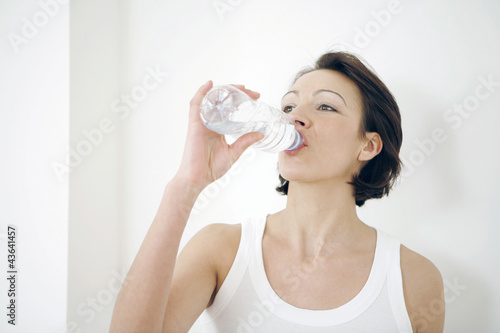 Photo: Woman drinking bottled water Woman drinking bottled water