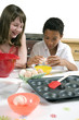 Boy and girl learning baking
