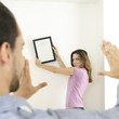 Man and woman hanging picture