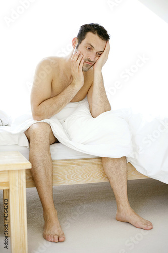 Photo: Man sitting on the bed Man sitting on the bed
