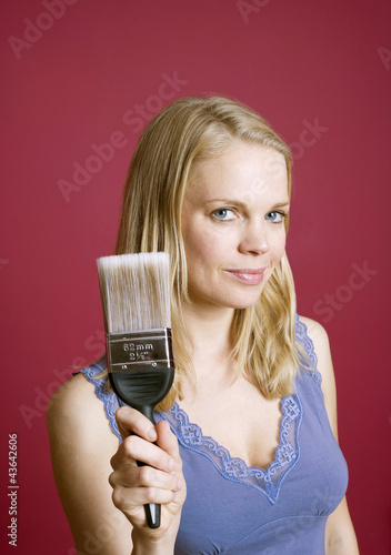 Photo: Woman holding a paint brush Woman holding a paint brush