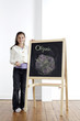 Photo : Girl smiling and holding onto blackboard Girl smiling and holding onto blackboard