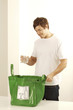 Man with glass and plastic bag for recycling