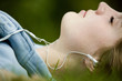 Girl listening to music while lying on grass