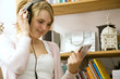 Girl looking at CD while listening to music on the headphones