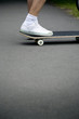 Boy's foot stepping on skateboard