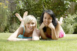 Photo: Two women lying forward in the park Two women lying forward in the park