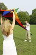 Man and woman flying kite in the park