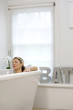 Woman resting in bathtub