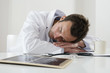 Male doctor resting on the table