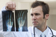 Photo: Male doctor looking at x-ray Male doctor looking at x-ray