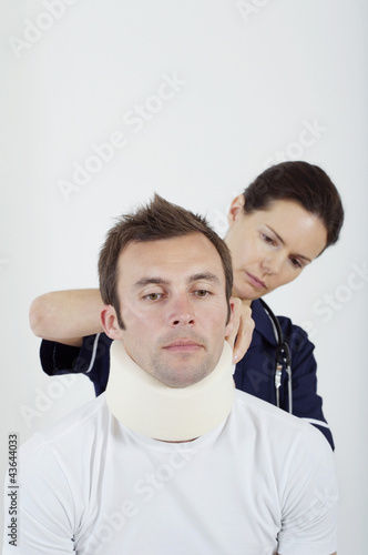 Photo: Female nurse treating a patient Female nurse treating a patient