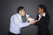 Businesswoman feeding businessman with a giant milk bottle
