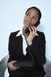 Photo: Businesswoman looking up while talking on the phone Businesswoman looking up while talking on the phone