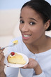 Woman enjoying a plate of cake
