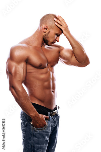 Foto: A young man with a beautiful physique thinking A young man with a beautiful physique thinking