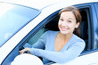 Pretty girl in a car smiling to you