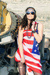 bright girl amongst stone captive with american flag