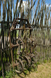 Old corroded field harrow tool stand wooden fence