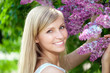 Smiling beautiful woman with violet flowers