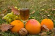 glass of white wine among a fruits in the grass