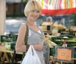 Photo: Woman buying vegetables at farmer's market Woman buying vegetables at farmer's market