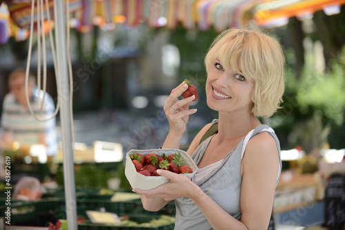Photo: Woman buying strawberries at farmer's market Woman buying strawberries at farmer's market