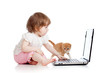 kid girl playing with kitten and laptop