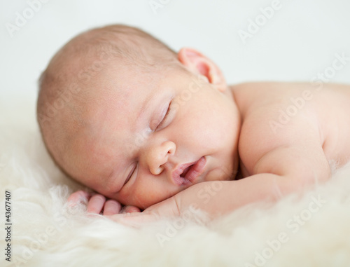 Photo: newborn baby girl sleeping on her stomach newborn baby girl sleeping on her stomach