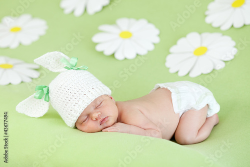 Photo: newborn baby girl sleeping on green meadow among daisy newborn baby girl sleeping on green meadow among daisy