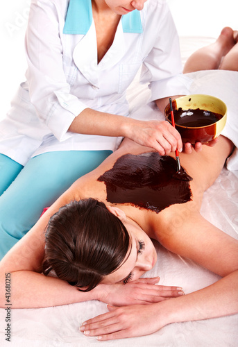 Photo: Girl having chocolate body mask. Girl having chocolate body mask.