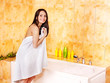 Woman undressing in bathroom