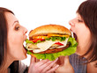 Women eating hamburger.