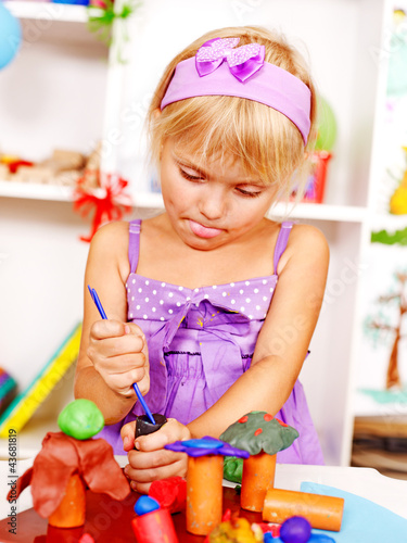 Photo: Child playing plasticine. Child playing plasticine.