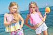 Photo: Two little girls with fruit Two little girls with fruit