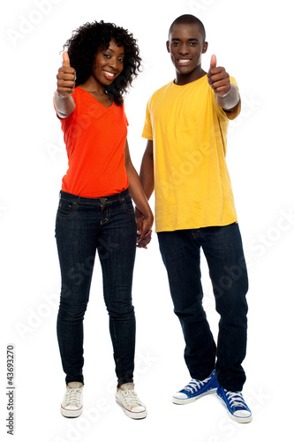 Photo: Happy african couple showing thumbs up Happy african couple showing thumbs up