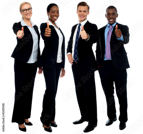 Photo: Corporate team gesturing thumbs up Corporate team gesturing thumbs up