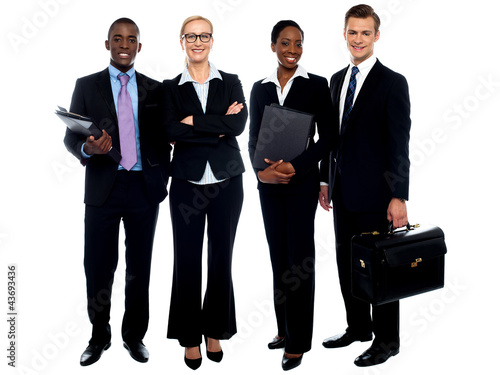 Photo: Happy smiling business team standing in a row Happy smiling business team standing in a row