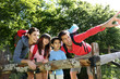Family on a hiking day resting along fence