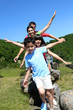 Family of four standing on rocks in the mountain
