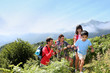 Family in a hikking day climbing up the hill