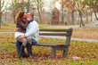 Young couple kissing while sitting on the bench
