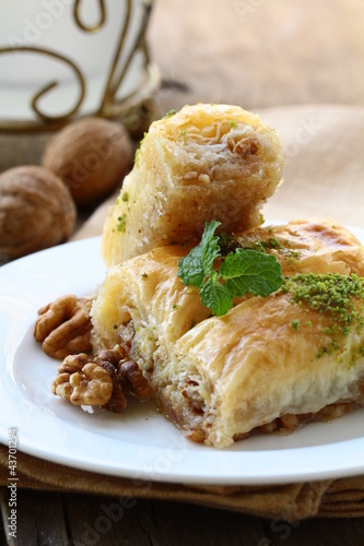 Photo: traditional Turkish arabic dessert - baklava with honey and nuts traditional Turkish arabic dessert - baklava with honey and nuts