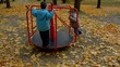 Kids playing on carousel and leaving after while