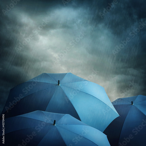 Foto: Dark clouds and umbrellas Dark clouds and umbrellas