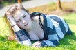 Attractive young caucasian female lies on grass