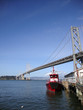 Fireboat docked in front of the San Francisco-Oakland Bay Bridge